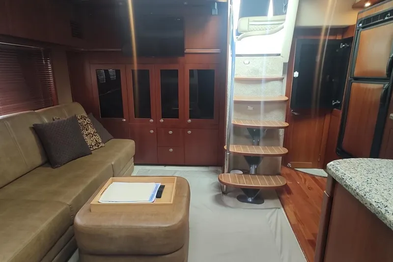 Slide: The Image of Luxurious interior of 2006 Sea Ray 48 Sundancer yacht with elegant seating and wooden stairs. - 14