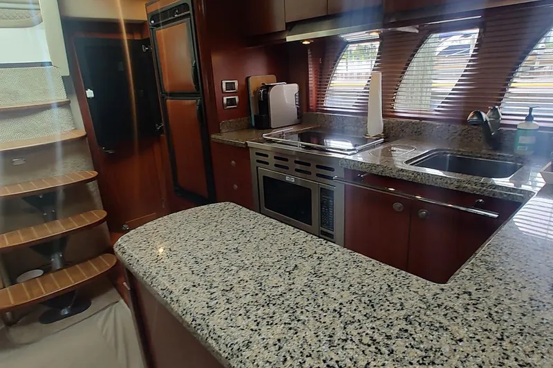 Slide: The Image of Luxurious 2006 Sea Ray 48 Sundancer yacht kitchen with granite countertops and modern appliances. - 15