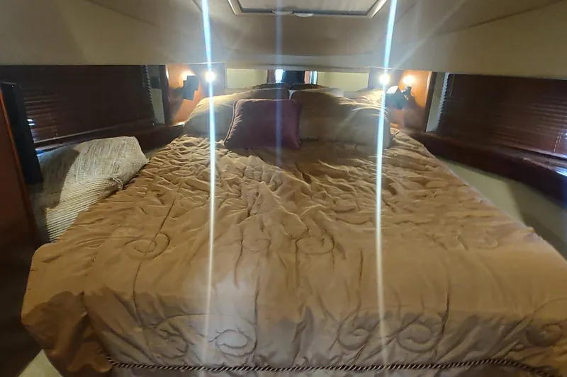 Slide: The Image of Luxurious bedroom interior of 2006 Sea Ray 48 Sundancer yacht with cozy bedding. - 17