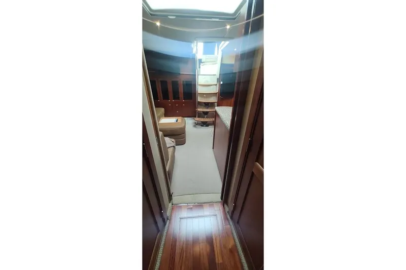 Slide: The Image of Interior view of 2006 Sea Ray 48 Sundancer yacht, featuring elegant wood flooring and cozy seating. - 18