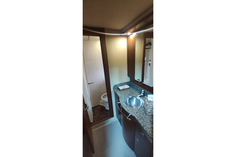 Slide: The Image of Bathroom interior of 2006 Sea Ray 48 Sundancer yacht with granite countertop and modern fixtures. - 19