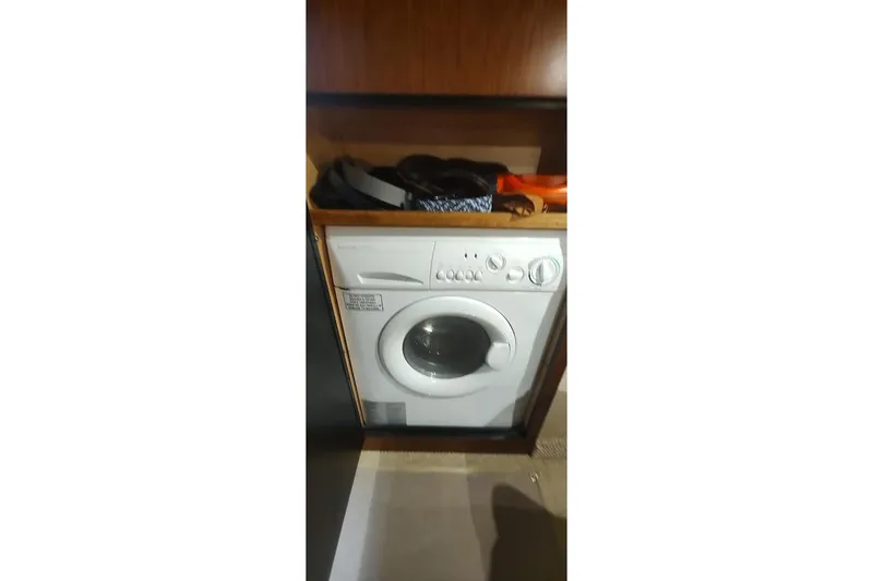 Slide: The Image of Washing machine inside 2006 Sea Ray 48 Sundancer yacht, wooden cabinetry. - 21
