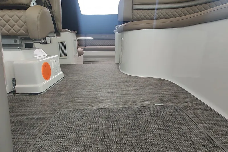 Slide: The Image of Interior of 2006 Sea Ray 48 Sundancer yacht with cushioned seating and carpeted flooring. - 23