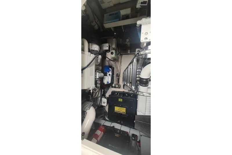 Slide: The Image of Engine room of 2006 Sea Ray 48 Sundancer yacht, showcasing mechanical components and systems. - 24