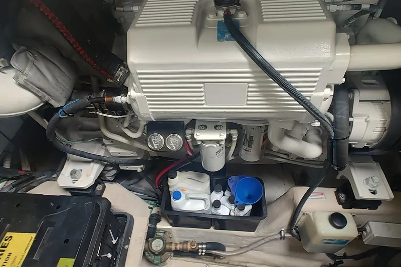 Slide: The Image of Engine compartment of a 2006 Sea Ray 48 Sundancer boat, showcasing mechanical components. - 25