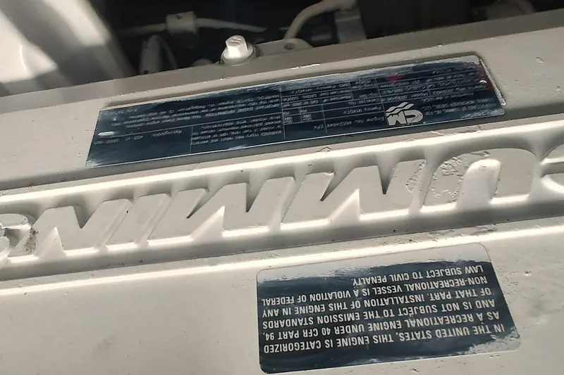 Slide: The Image of Engine detail of a 2006 Sea Ray 48 Sundancer boat, featuring Cummins branding. - 29
