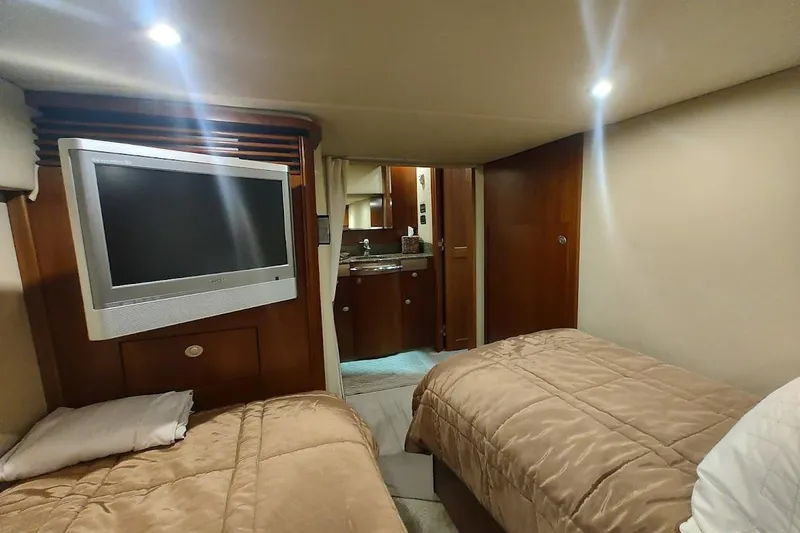 Slide: The Image of Interior cabin of 2006 Sea Ray 48 Sundancer yacht with twin beds and TV. - 33