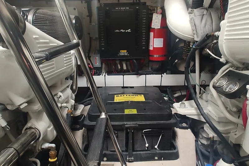 Slide: The Image of Engine room of 2006 Sea Ray 48 Sundancer, featuring battery and mechanical components. - 46