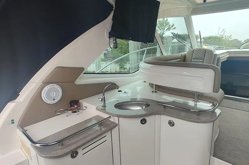Slide: The Image of Interior of 2006 Sea Ray 48 Sundancer yacht with sleek kitchenette and seating area. - 6