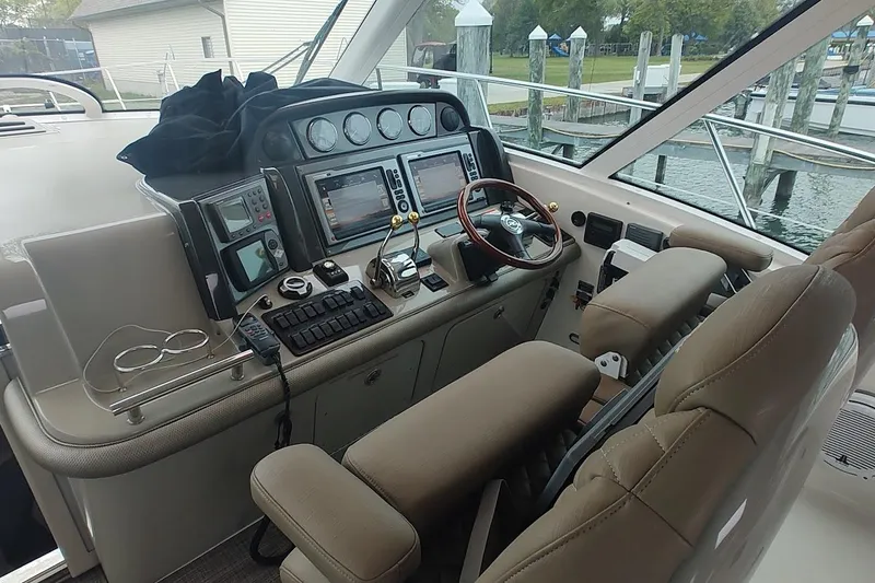 Slide: The Image of Helm of 2006 Sea Ray 48 Sundancer with advanced navigation controls and leather seating. - 8