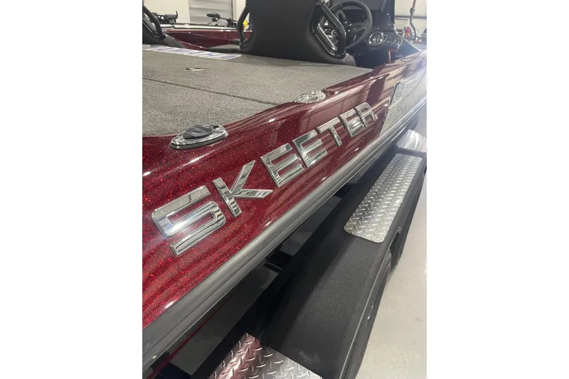 Slide: The Image of Red 2022 Skeeter ZXR21 boat with metallic finish and visible logo. - 18