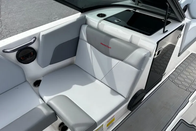 Slide: The Image of 2023 MasterCraft NXT22 boat interior with gray seating and modern design. - 5