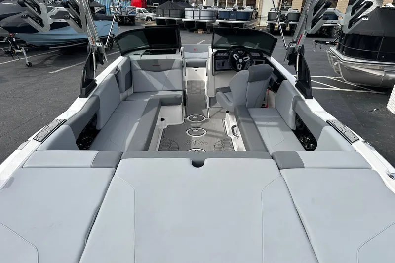 Slide: The Image of 2023 MasterCraft NXT22 boat interior with sleek seating and modern dashboard design. - 8