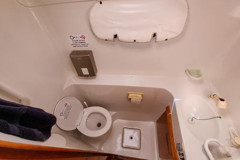 Slide: The Image of Compact bathroom interior of 2001 Privilege 435 yacht with sink and wooden accents. - 101