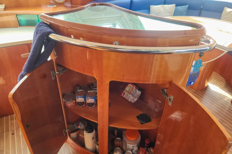 Slide: The Image of Wooden cabinet interior on a 2001 Privilege 435 yacht, showing storage and plumbing. - 114