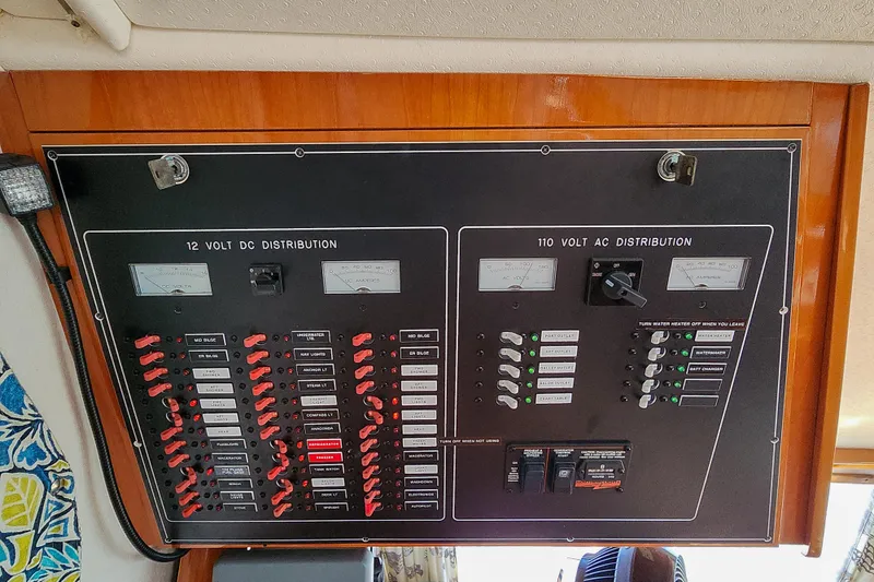 Slide: The Image of Marine watermaker system in a 2001 Privilege 435 yacht, featuring gauges and warning label. - 119