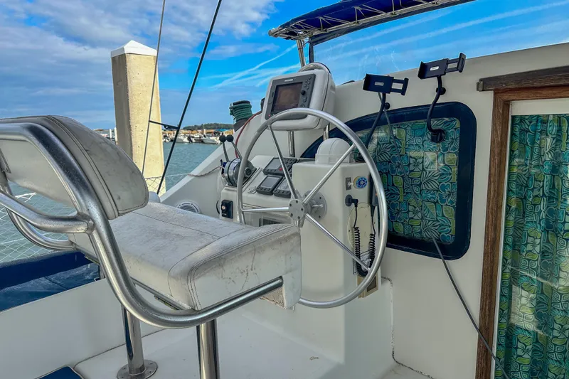 Slide: The Image of Cockpit of 2001 Privilege 435 yacht with steering wheel and navigation equipment. - 12