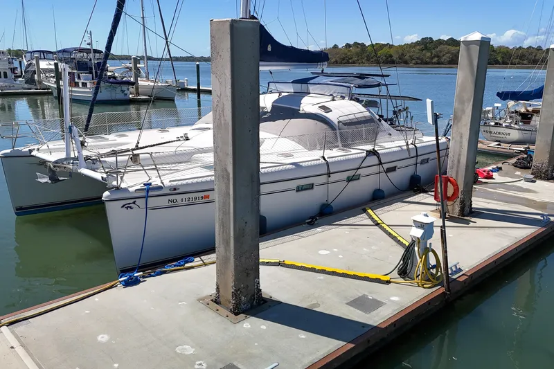 Slide: The Image of Aerial view of a 2001 Privilege 435 catamaran docked at a marina. - 144