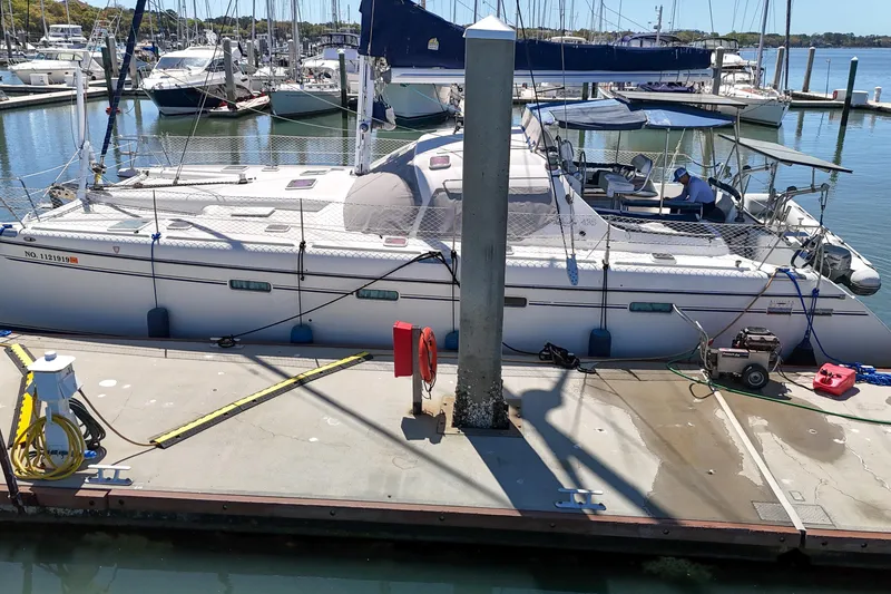 Slide: The Image of Catamaran Privilege 435, 2001 model, docked at marina with clear blue sky. - 145