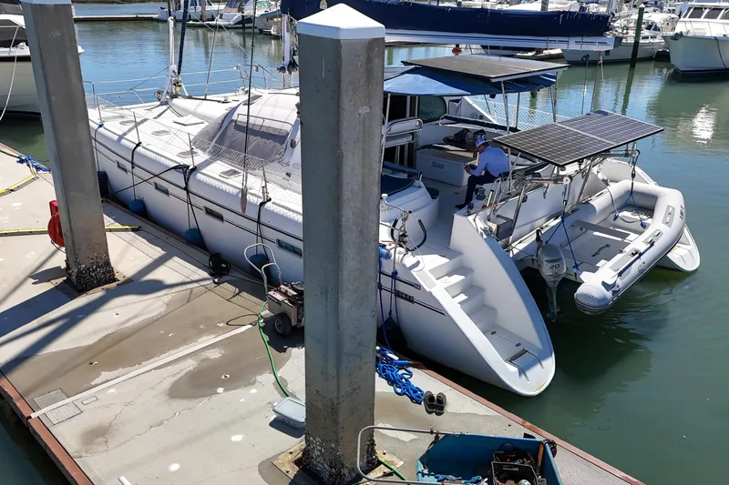 Slide: The Image of Sailing catamaran Privilege 435, 2001 model, docked at a serene marina. - 146