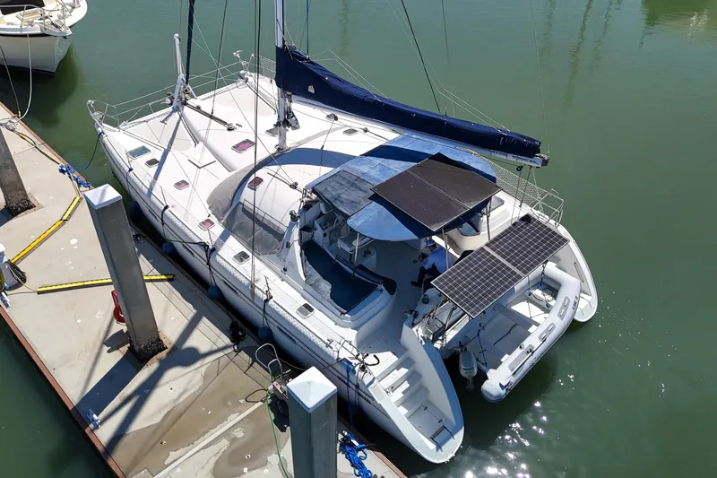 Slide: The Image of Aerial view of a 2001 Privilege 435 catamaran docked at a marina. - 147