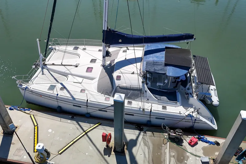 Slide: The Image of Inflatable boat docked beside a pier, featuring a Honda outboard motor. - 148