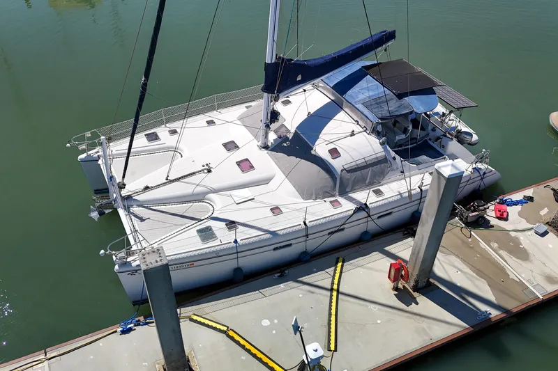 Slide: The Image of Sailboat Privilege 435 (2001) with blue sail design and dog on deck. - 149