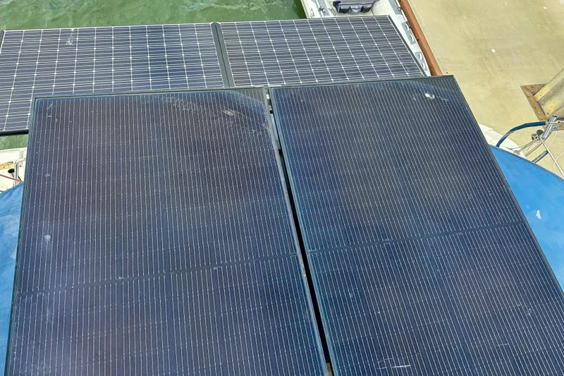 Slide: The Image of Solar panels on a 2001 Privilege 435 catamaran, docked near water. - 15