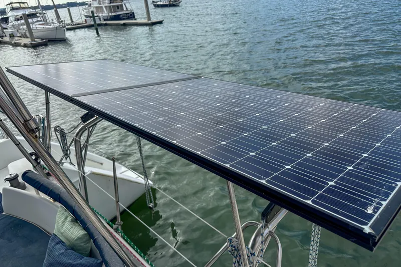 Slide: The Image of Solar panels on a 2001 Privilege 435 catamaran docked at a marina. - 16