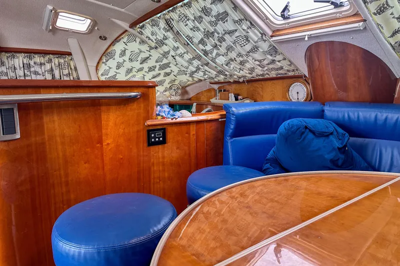 Slide: The Image of Interior of 2001 Privilege 435 yacht with blue seating and wooden finishes. - 20