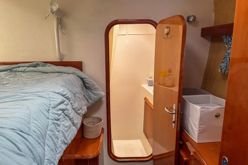 Slide: The Image of Cozy cabin interior of 2001 Privilege 435 yacht with bed and storage. - 29