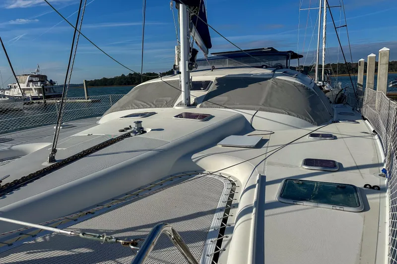 Slide: The Image of Sailing catamaran Privilege 435, 2001 model, docked at marina under clear blue sky. - 3