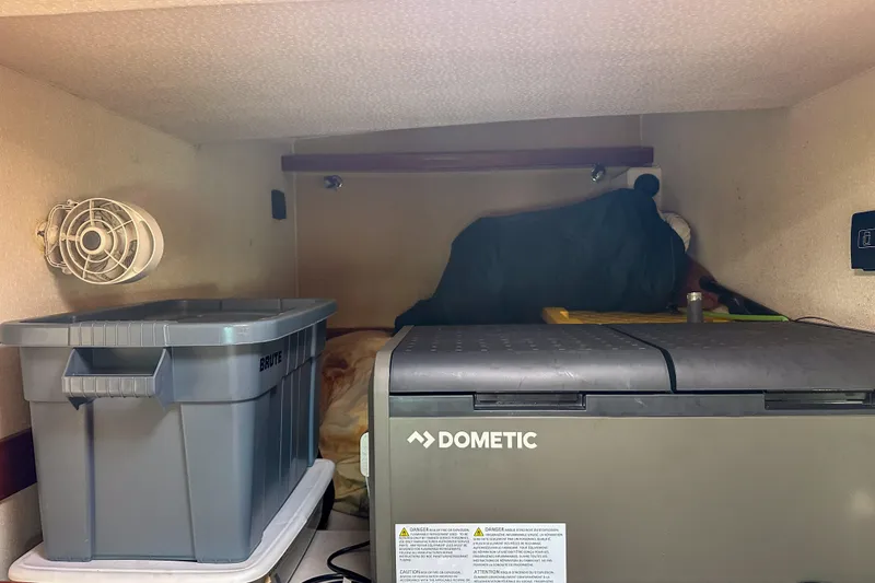 Slide: The Image of Storage area in a 2001 Privilege 435 with Dometic cooler and Brute container. - 35