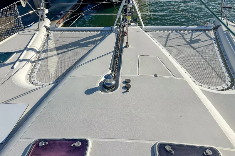 Slide: The Image of Deck view of a 2001 Privilege 435 catamaran with netting and winch. - 4