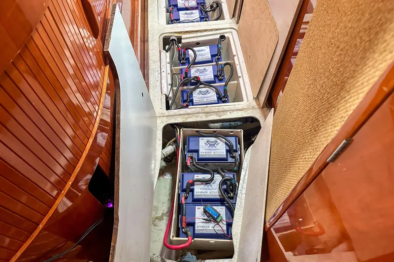 Slide: The Image of Battery compartment of a 2001 Privilege 435 yacht, showcasing multiple connected batteries. - 44