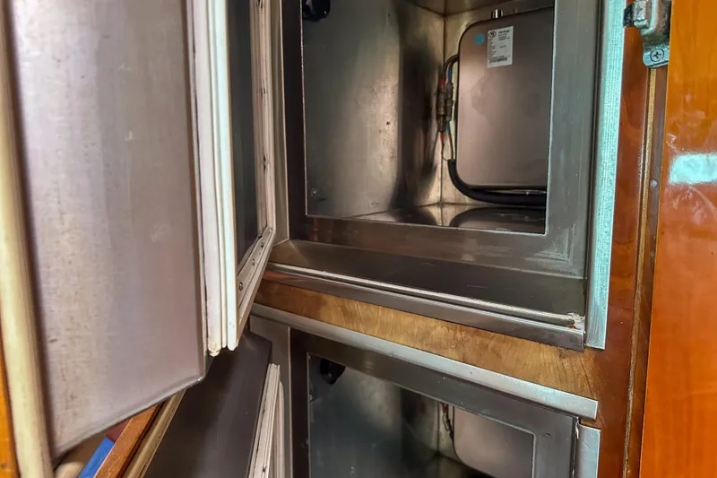 Slide: The Image of Stainless steel storage compartments inside a 2001 Privilege 435 yacht. - 45