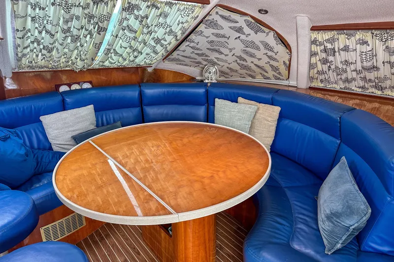 Slide: The Image of Interior of 2001 Privilege 435 yacht with blue seating and wooden finishes. - 54