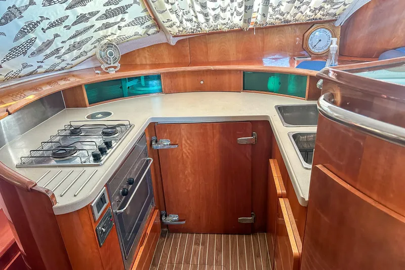 Slide: The Image of Luxurious 2001 Privilege 435 yacht interior with blue seating and wooden table. - 55