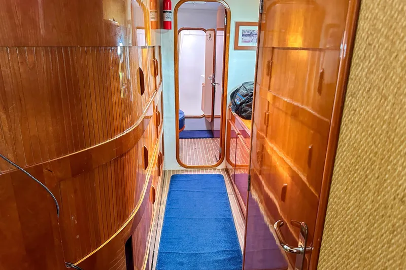 Slide: The Image of Interior of 2001 Privilege 435 yacht with wooden flooring and blue seating. - 58