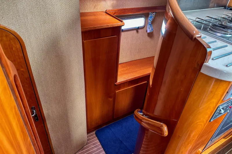 Slide: The Image of Compact kitchen area in a 2001 Privilege 435 yacht with stove and oven. - 64