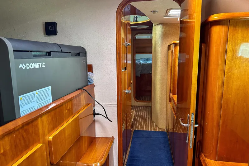 Slide: The Image of Open wooden cabinet in Privilege 435 yacht interior, displaying canned goods and kitchen items. - 67