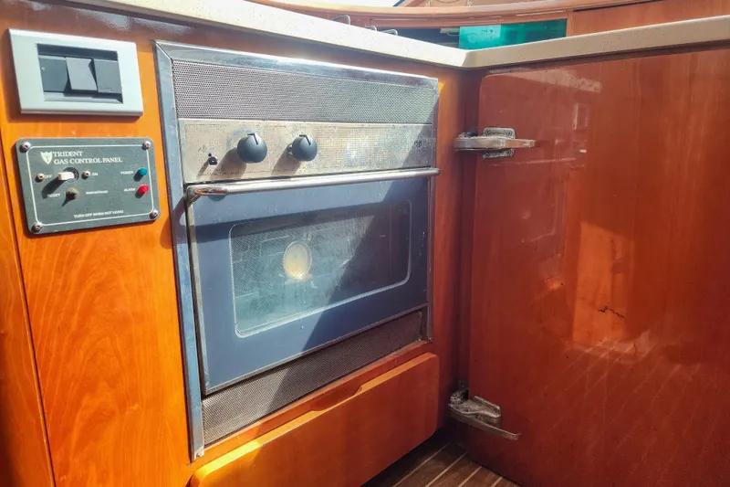 Slide: The Image of Cozy cabin interior of 2001 Privilege 435 yacht with wooden shelves and patterned bedding. - 75