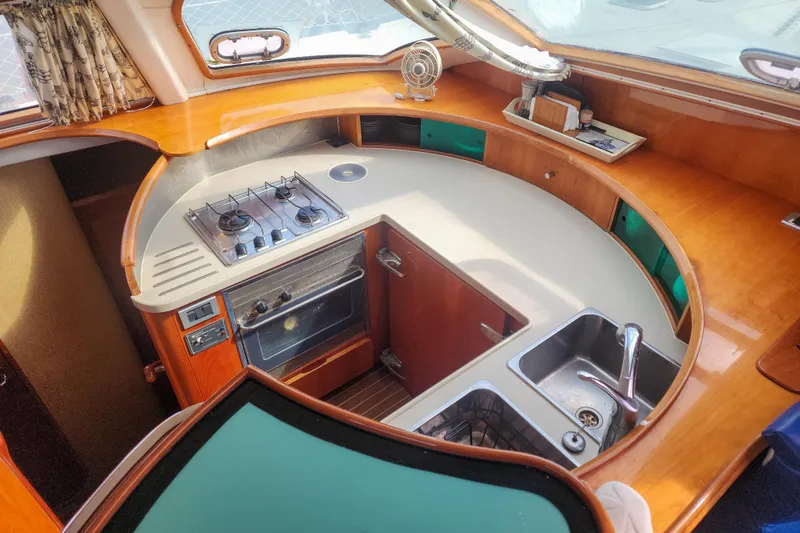 Slide: The Image of Interior of 2001 Privilege 435 yacht with cozy cabin and storage shelves. - 76