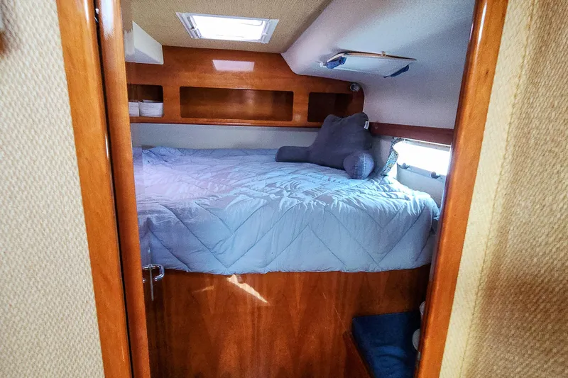 Slide: The Image of Interior of 2001 Privilege 435 yacht with wooden cabinetry and storage compartments. - 82