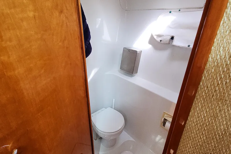 Slide: The Image of Cozy cabin bed in 2001 Privilege 435 yacht with blue bedding and basket of towels. - 84