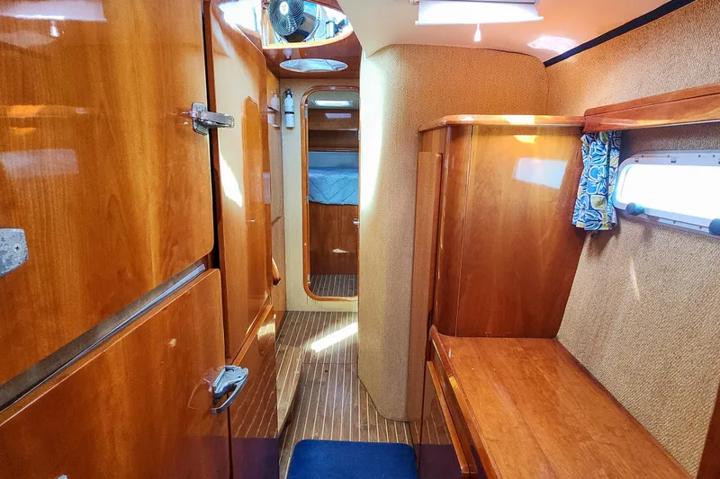 Slide: The Image of Cozy cabin interior of 2001 Privilege 435 yacht with wooden finish and blue accents. - 86