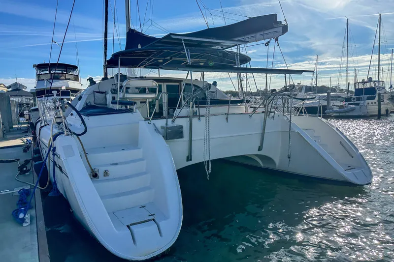 Slide: The Image of Catamaran Privilege 435, 2001 model, docked at marina under clear blue sky. - 9