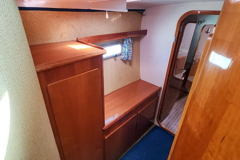 Slide: The Image of Interior of 2001 Privilege 435 yacht with wooden furnishings and cozy bedding. - 90