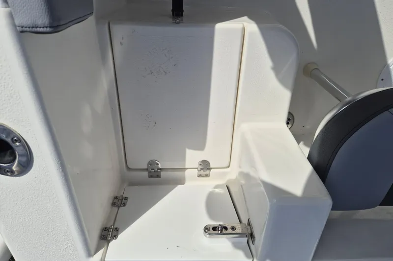 Slide: The Image of Interior view of 2026 Defiance Catalina 240 boat, featuring storage compartment and seating. - 10