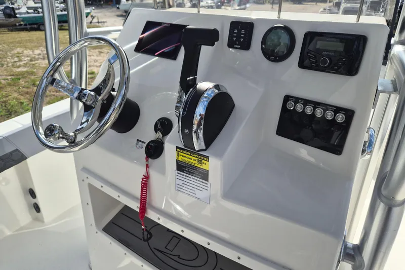 Slide: The Image of 2026 Defiance Catalina 240 boat dashboard with steering wheel and control panel. - 13